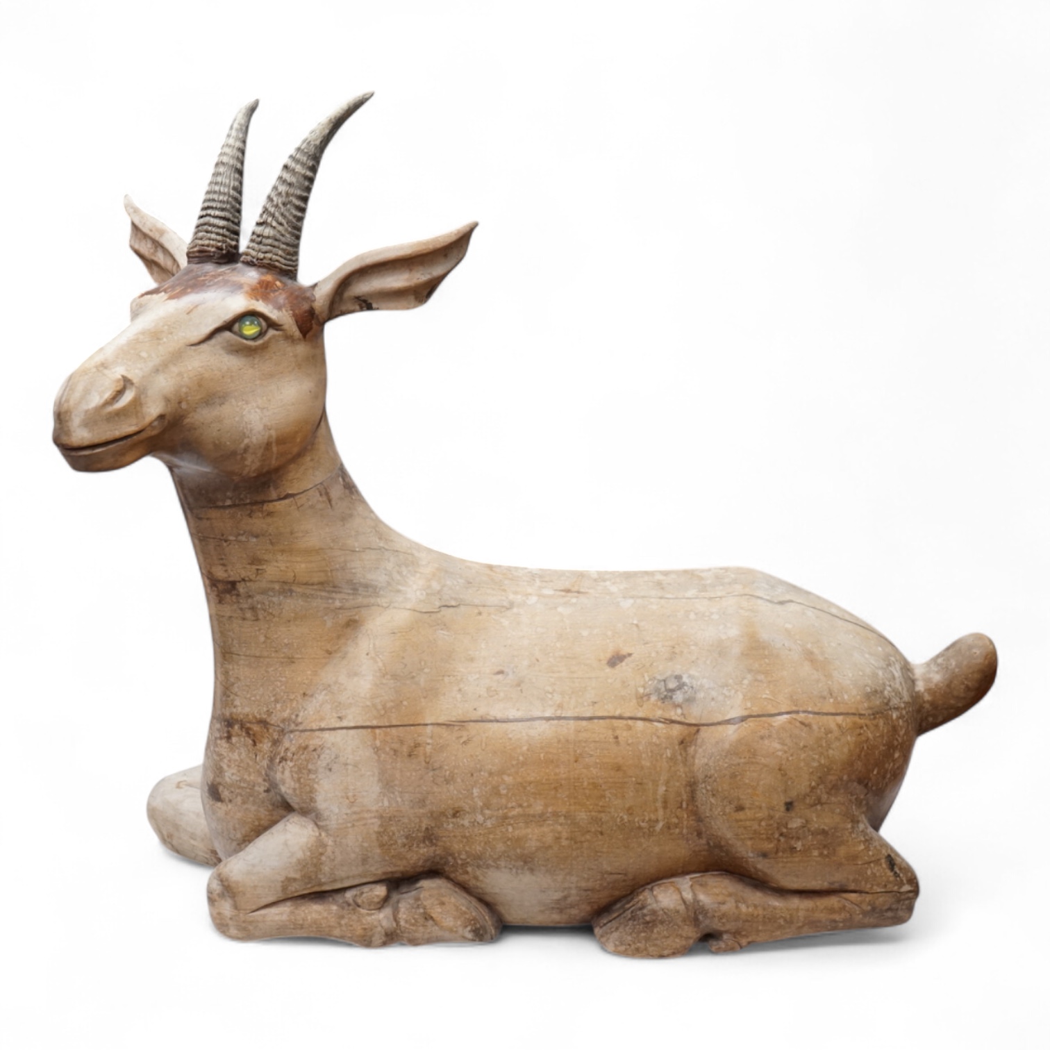 A large Vietnamese hardwood model of a recumbent goat, 78cm wide